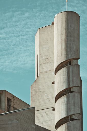 The Christi Auferstehung church tower with spiral staircase on blue sky background in Cologne, Germany
