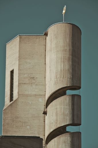 A vertical shot of a church tower with a spiral staircase