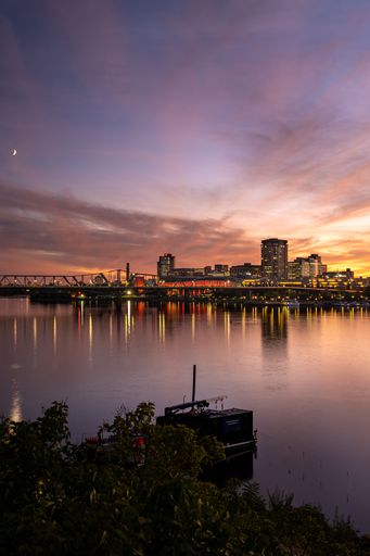 A long exposure shot of Gatineau under a colorful sunset sky with the moon