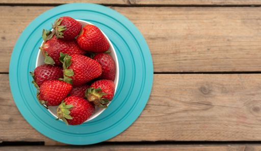 A top view of fresh strawberries in a bowl