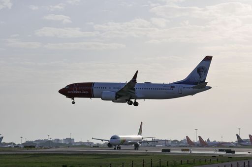 A low-angle of a Boeing 737 MAX 8 airplane of Norwegian (Elsa Beskow Livery) airline, landing at Lisbon's airport, at sunrise