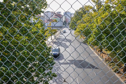 The view of the street along the Campo Grande Garden behind the mesh fences in Lisbon, Portugal