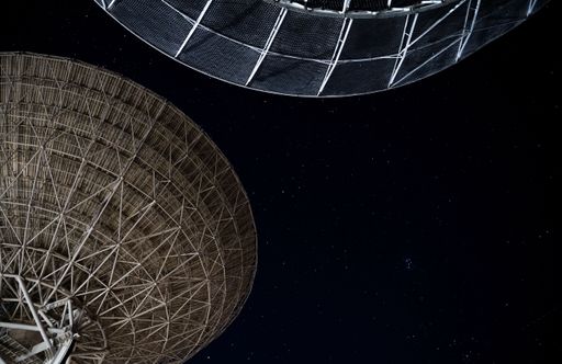 Two huge Radio Astronomers under a starry night