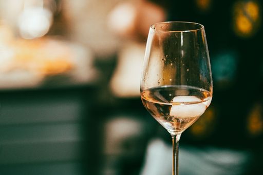 A shallow focus of a glass white wine with blurred background