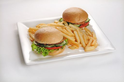 An isolated shot of a plate with two burgers and french fries - perfect for a food blog or menu usage