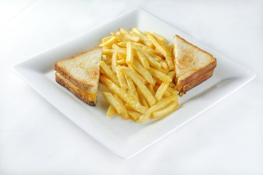 An isolated shot of a white plate with ham and cheese sandwich- perfect for a food blog or menu usage