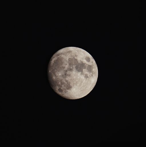 A beautiful textured gray shining full moon in a black night sky