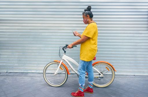 A closeup focus shot of a woman standing next to her bicycle