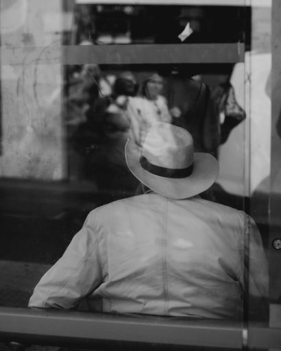 A back view of male wearing hat at the bus station
