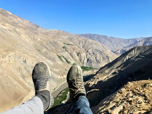 A closeup shot of hikers feet with a landscape in the background
