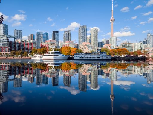A scenic view of Toronto city and the CN tower reflecting on the surface of the lake
