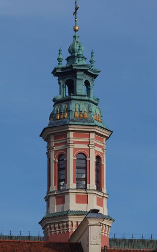 A vertical shot of Adorned tower of a historical building in old town market square, Warsaw, Poland