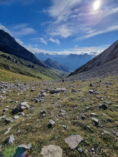 A vertical shot of green hills under a blue sky with clouds in Asturias, Spain.