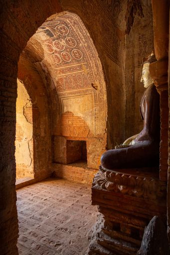 Buddha figure overlooks the entrance to a small temple in Bagan, Myanmar (Burma).