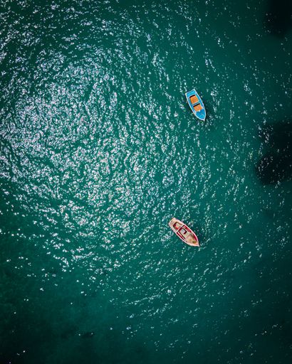 Two boats at the coast of Milos in Greece, aerial shot