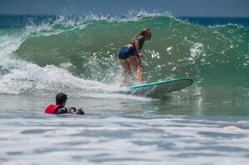 A Male Photographer trying to capture the Surfer in Action