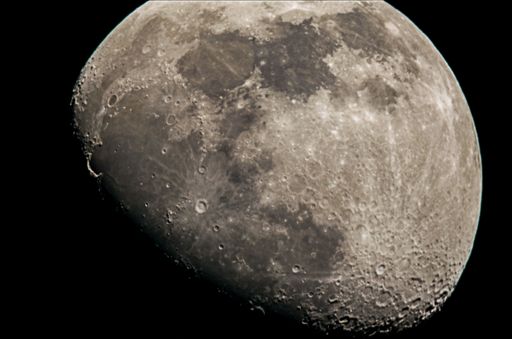 A breathtaking closeup view of the bright white full moon in the black sky