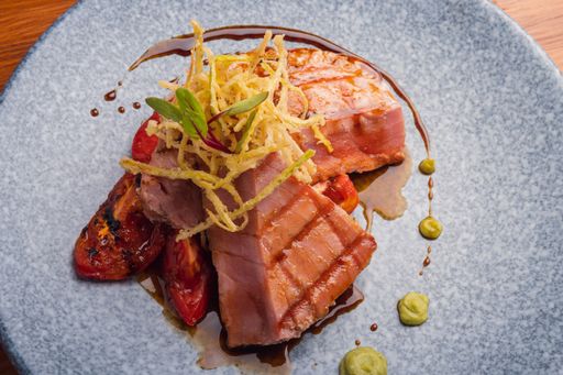 A closeup shot of a tasty dish with tuna steak and vegetables