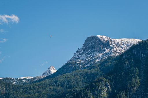 A low angle shot of rocky snowy mountains under a clear sky in Hallstatt, Austria