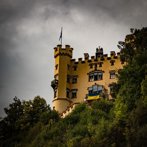A low angle shot of a historic yellow stone castle in Neuschwanstein, Germany