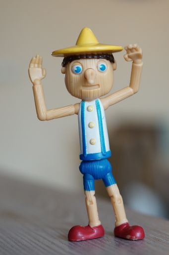 Plastic toy Pinocchio figurine on a table