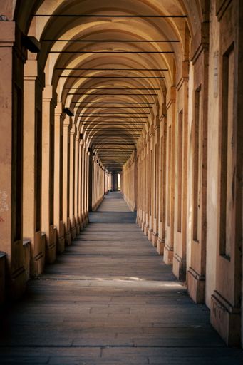 A vertical shot of 666 arches in Portici di Bologna towards Santuario Madonna di San Luca in Italy