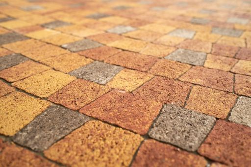 A selective focus shot of a texture of colorful brick floor - perfect for background or wallpaper