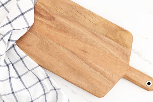 Empty cutting board on white marble background. Cuisine Kitchen background. Mock up
