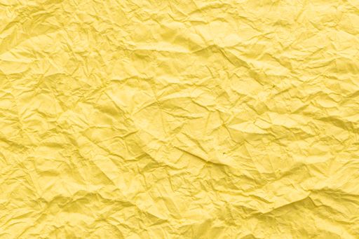 Yellow Crumpled paper abstract background texture. Full frame