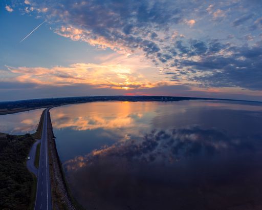 A landscape view of the narrow road near the Skanderborg lake at sunset