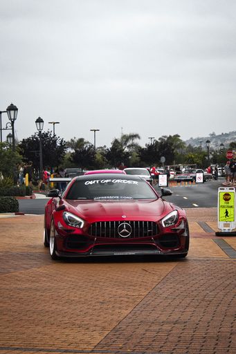 A vertical shot of the front of stunning red Wide Body Mercedes Benz AMG GT