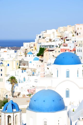 A vertical shot of the beautiful white Santorini in Greece