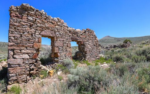 A stone wall is all that remains of an abandoned building in the historic mining settlement of Hamilton, Nevada.