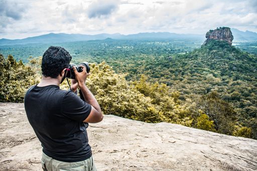A man taking pictures of Sigiriya with a professional camera, Sri Lanka