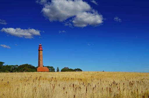 An image of a wheat field with a lighthouse on the background in Germany