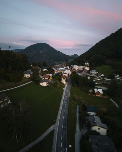 A drone vertical shot of sunset in a small rural village in the Austrian mountains