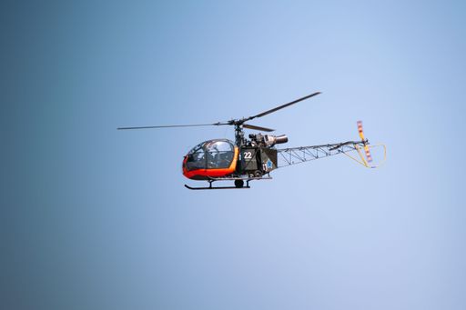 A French helicopter flying in a clear pale blue sky during an air show in Pretoria, South Africa on a sunny day