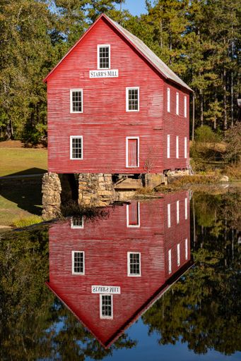 A vertical shot of a Starr's Mill reflection in water