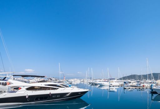 Boats parked in a blue sea under a clear sky