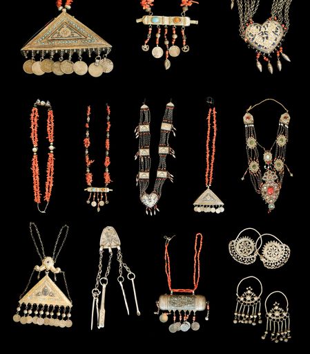 A Set of antique pendants and earrings with precious stones isolated on a black background