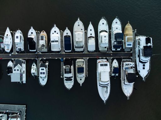 An aerial top view of boats in harbor on the tranquil Hawkesbury River in Brooklyn, Sydney