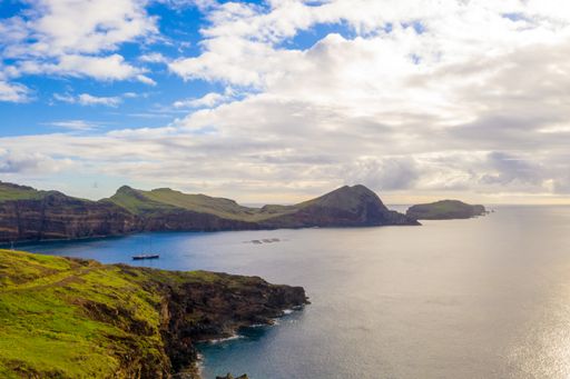 An aerial view of the wild beach and cliffs under a cloudy sky in Madeira islands, Portugal