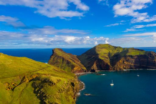 An aerial view of the wild beach and cliffs under a cloudy sky in Madeira islands, Portugal