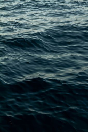 A closeup shot of small wave of a sea of blue water in daylight
