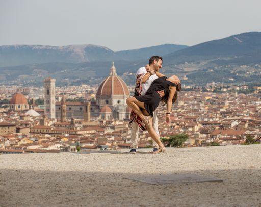 A loving couple dancing Argentinian tango with the Cathedral of Santa Maria del Fiore in the background