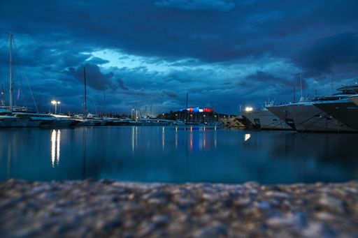 Antibes Fort Carre lightened up with the French flag at night. Picture shot right before a thunderstorm. Low-angle long exposure picture.