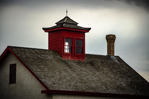A closeup of a brick house and red chimney