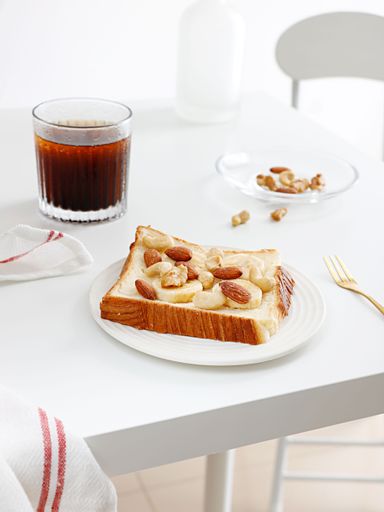 A top view of a Peanut Butter Banana Toast on white table