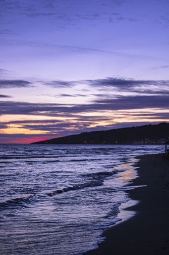A beautiful vertical shot of a sunset sky near the beach