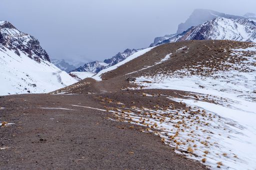 A Landscape of snow covered mountains under blue sky
